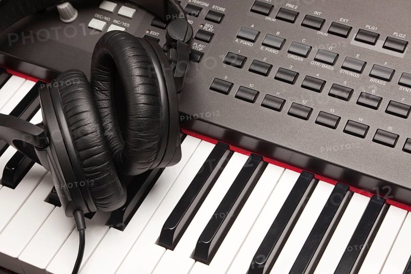 Headphones laying on electronic keyboard with narrow depth of fiel