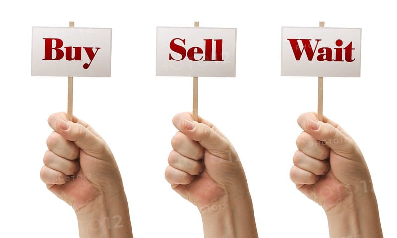 Three signs in male fists saying buy