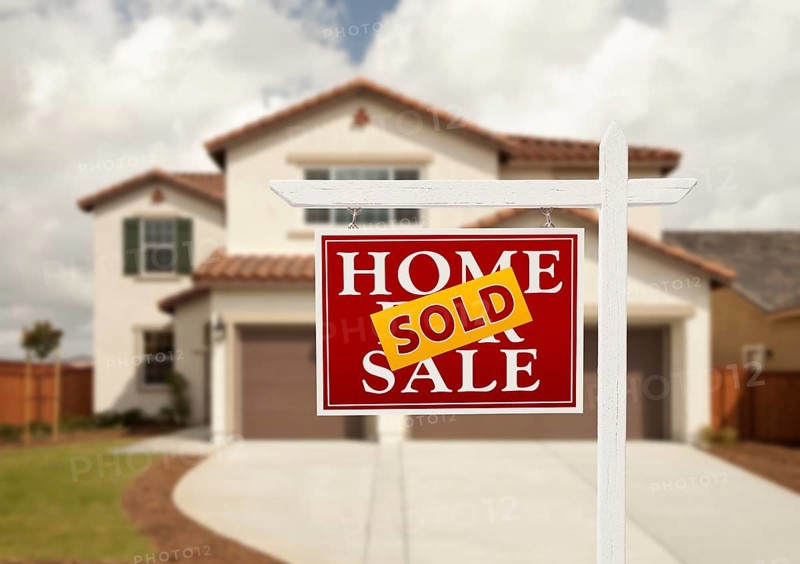 Sold home for sale real estate sign in front of new house