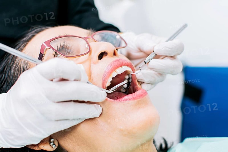 Female dentist checking a patient