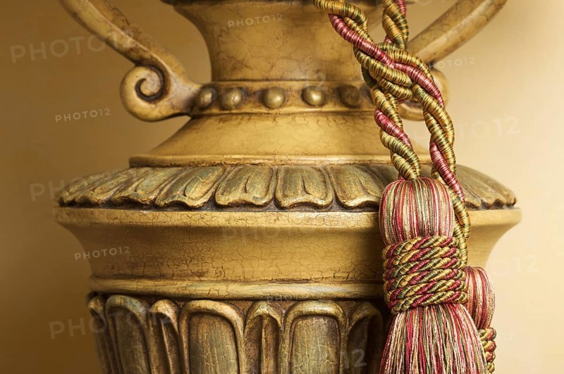 Lamp on table with ornate hanging tassel
