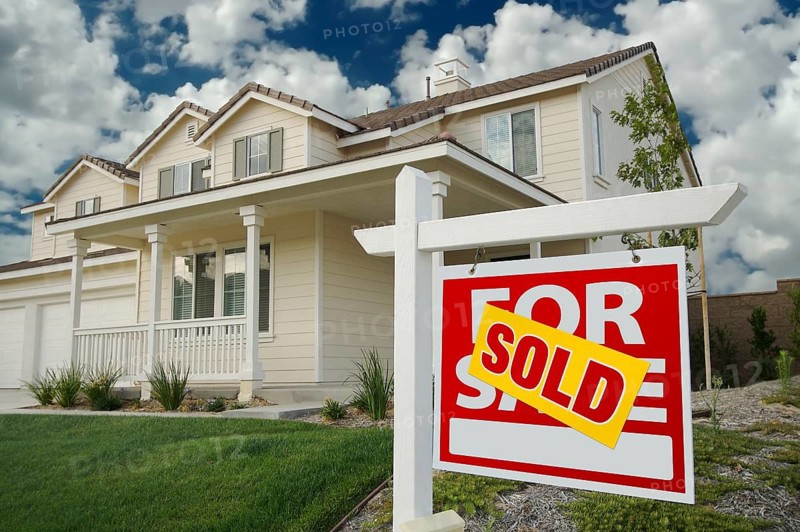 Sold home for sale sign in front of new house