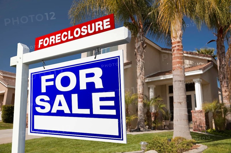 Foreclosure for sale real estate sign in front of house