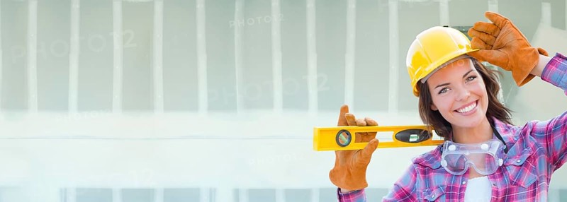 Female contractor wearing hard hat against dywall banner background with ladder