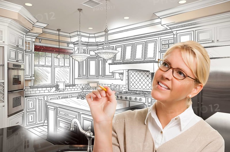 Creative woman with pencil over custom kitchen design drawing and photo combination