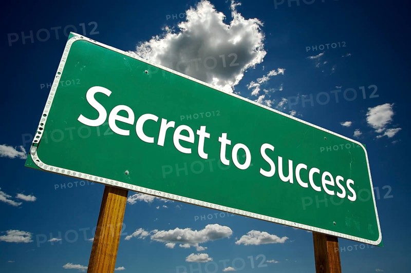 Secret to success road sign with dramatic clouds and sky