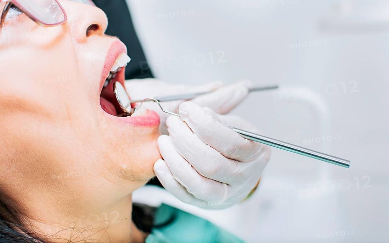 Dentist checking patient's mouth