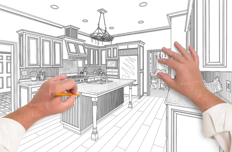 Male hands sketching with pencil the outline of a beautiful custom kitchen