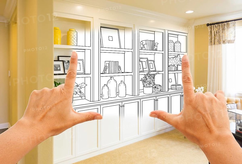 Hands framing custom built-in shelves and cabinets design drawing with section of finished photo