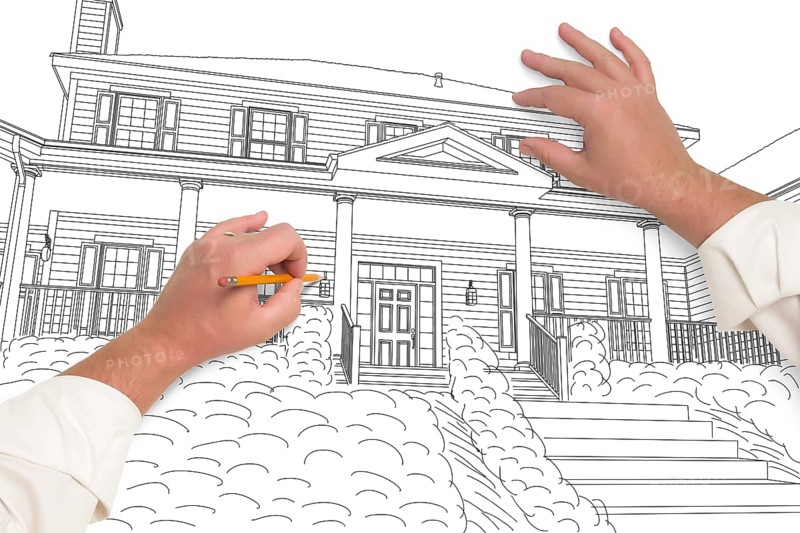 Male hands sketching with pencil the outline of a beautiful house on white