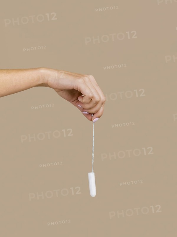 hand holding tampon front view