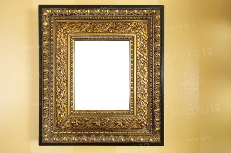 Ornate blank picture frame on yellow wall