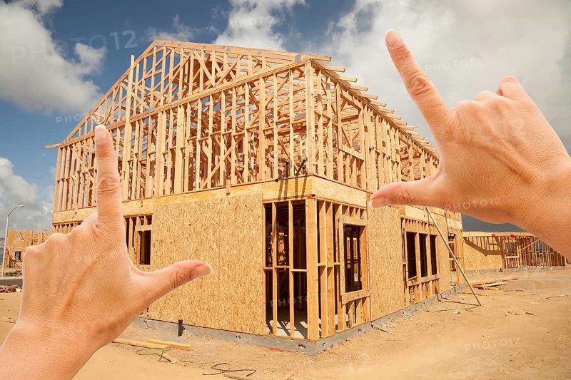 Female hands framing new home frame on construction site