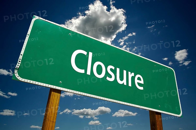 Closure road sign with dramatic clouds and sky