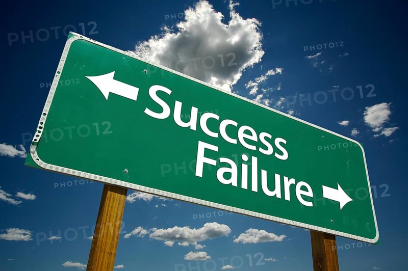 Success and failure road sign with dramatic clouds and sky