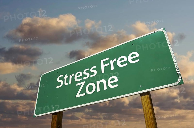 Stress free zone green road sign in front of dramatic clouds and sky