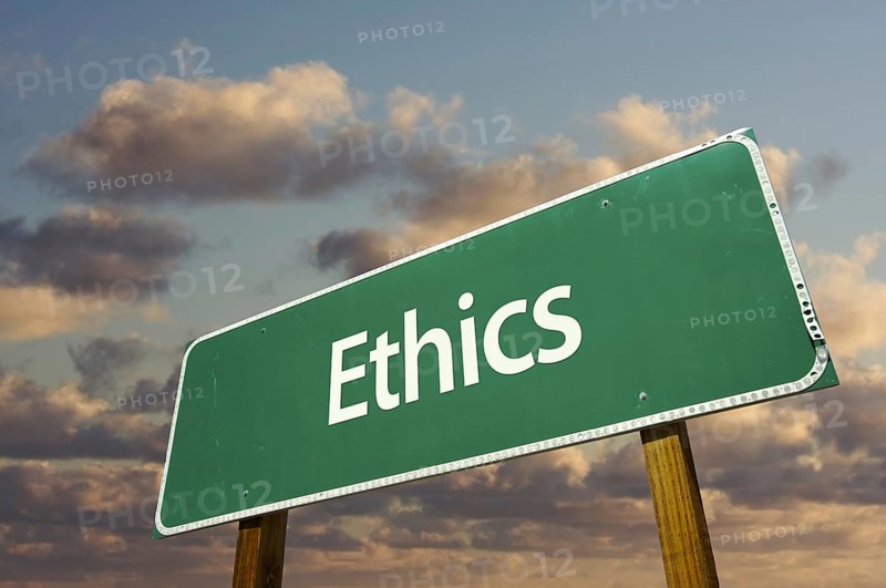 Ethics green road sign with dramatic blue sky and clouds