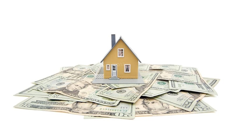 Home and money isolated on a white background
