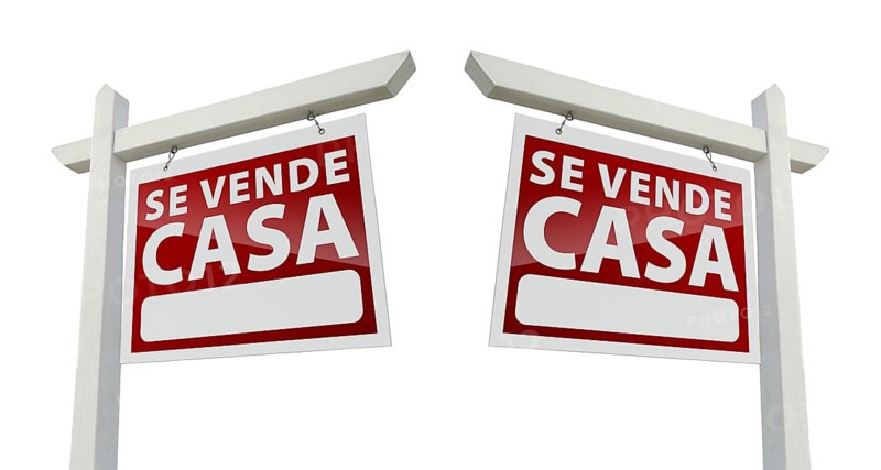Two spanish house for sale real estate signs with clipping paths isolated on a white background