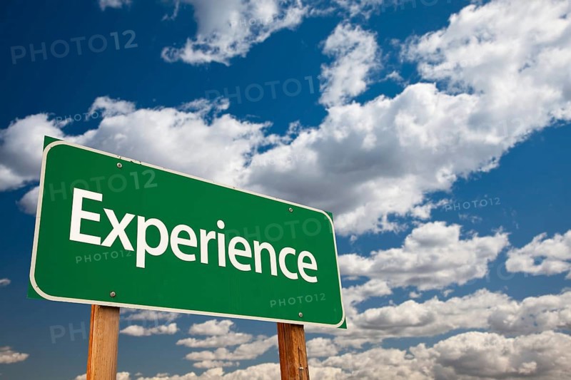 Experience green road sign with copy room over the dramatic clouds and sky