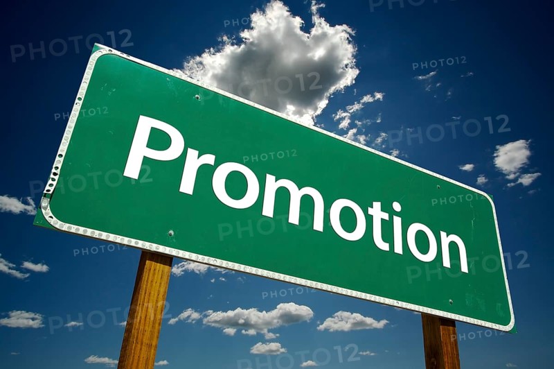 Promotion road sign with dramatic clouds and sky