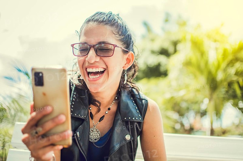 Close up of a happy girl checking her cell phone
