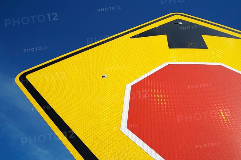 Very reflective stop ahead sign abstract on a blue sky