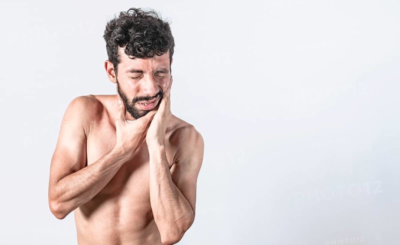 Man with earache on isolated background
