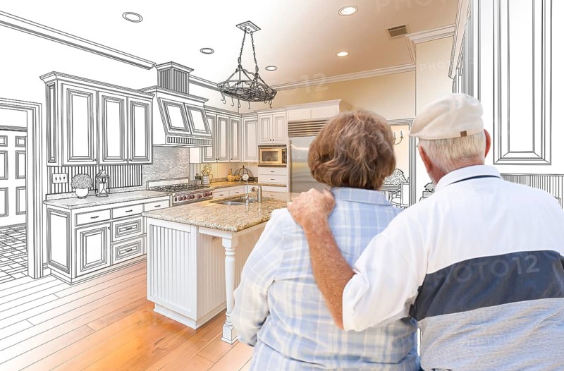 Senior couple looking over custom kitchen design drawing and photo combination