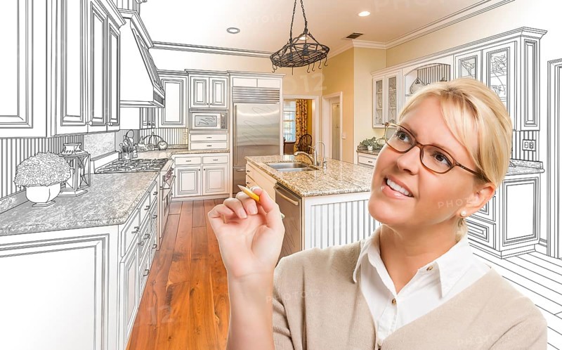 Creative woman with pencil over custom kitchen design drawing and photo combination