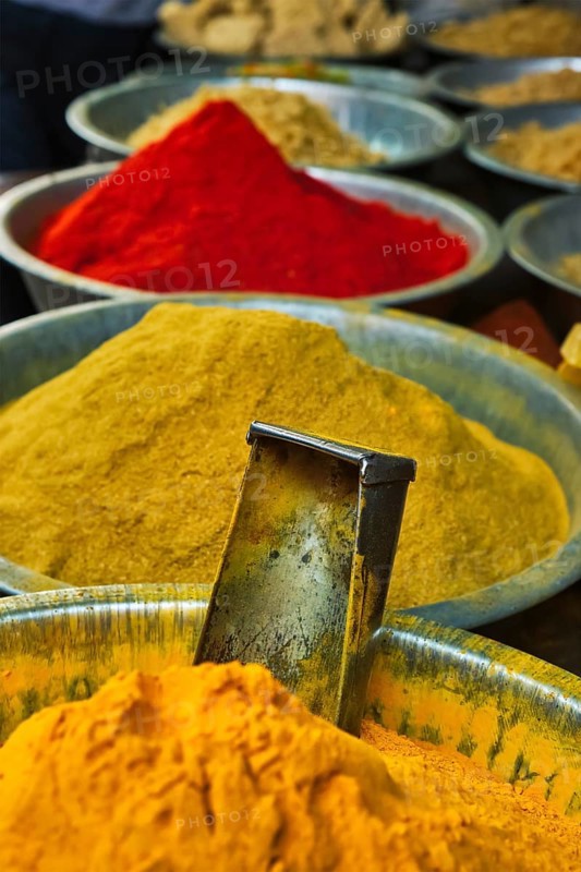 Turmeric curcuma powder and chili powder in spices market in India. Sardar Market