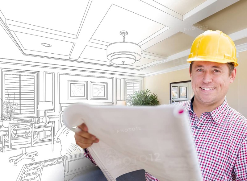 Smiling contractor in hard hat with roll of plans over custom bedroom drawing and photo combination