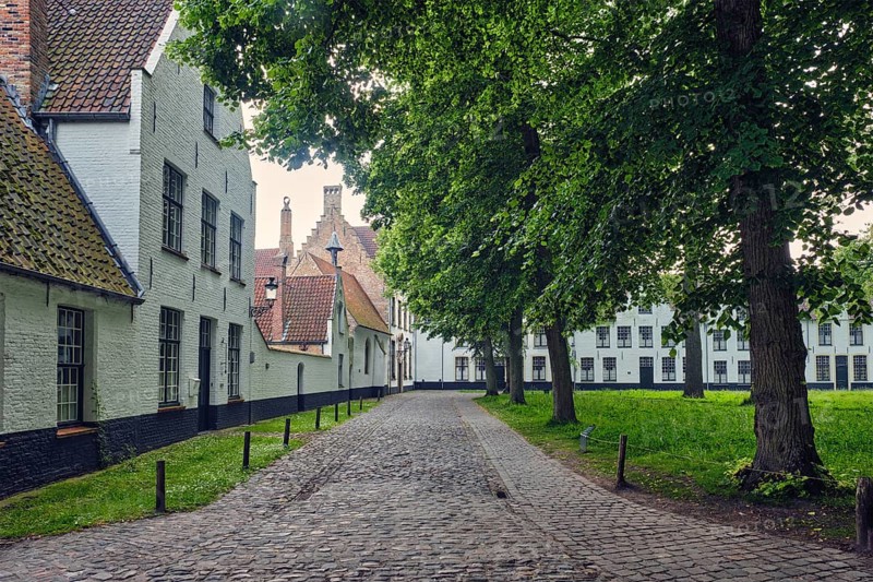 Old houses and garden of Begijnhof Beguinage in Bruges town