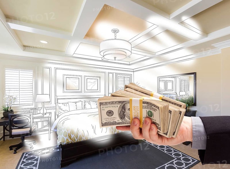 Man handing over stack of money above bedroom drawing photograph combination