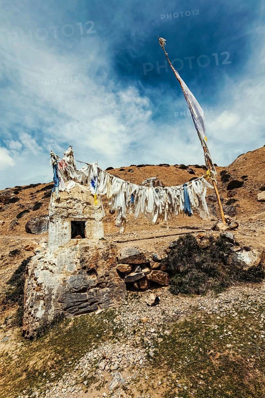 Tibetan Buddhist prayer flags lungta with Om mani padme hum mantra written on them in Spiti Valley in Himalayas