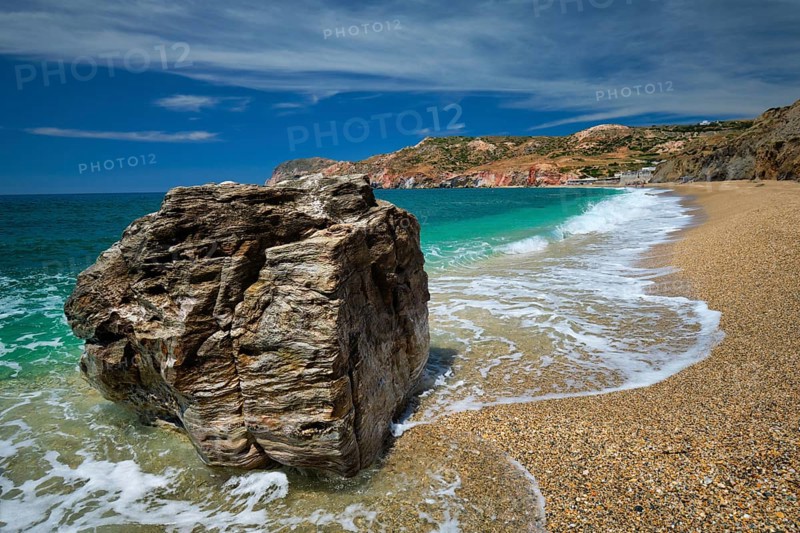 Rocks on Paleochori beach and waves of Aegean sea
