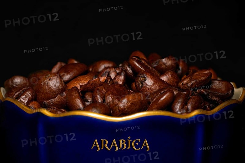 Roasted Arabica coffee in a porcelain cup in cobalt blue with gold rim and the inscription Arabica