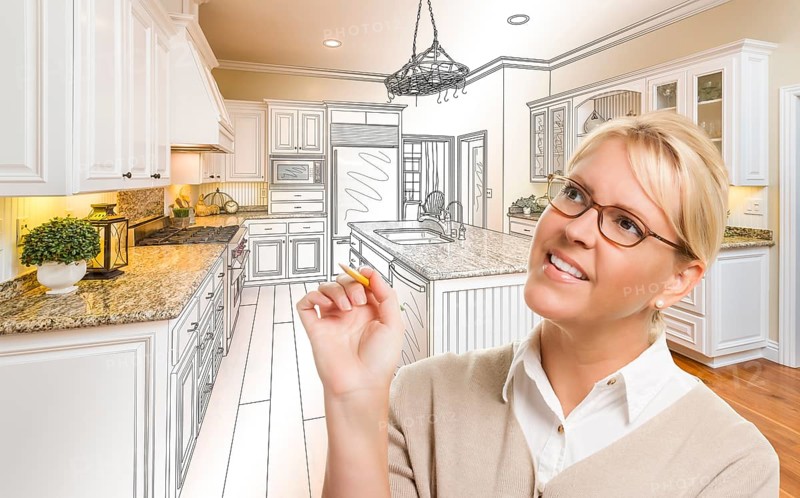 Creative woman with pencil over custom kitchen design drawing and photo combination