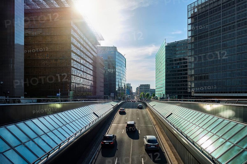 Street traffic in Brussels near European Commission building on sunset Rue de la Loi