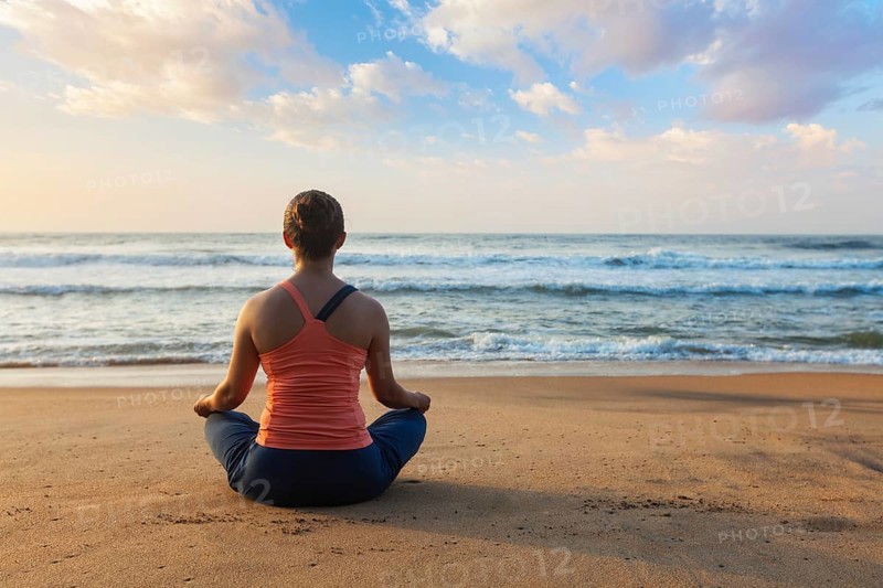 Young sporty fit woman doing yoga