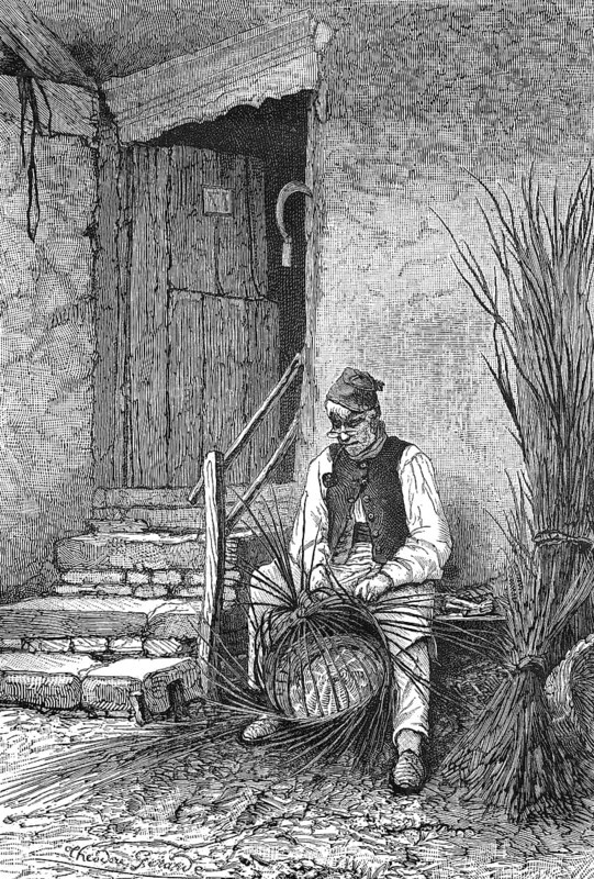 Basket weaver sitting in front of his house weaving a wicker basket