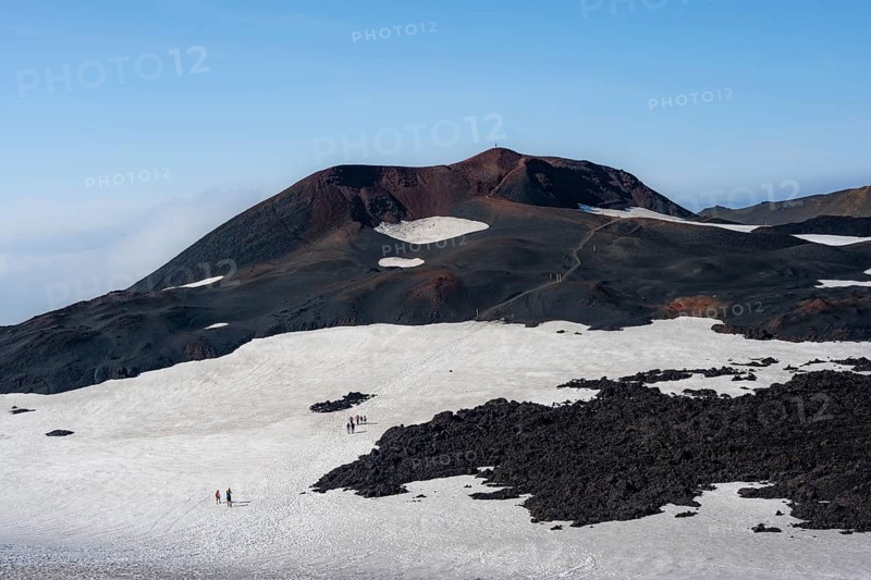 Hikers in the distance on a snow field