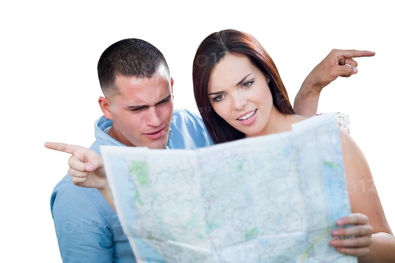 Young lost and confused military couple looking at map isolated on white