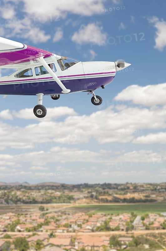 The cessna 172 single propeller airplane flying in the sky