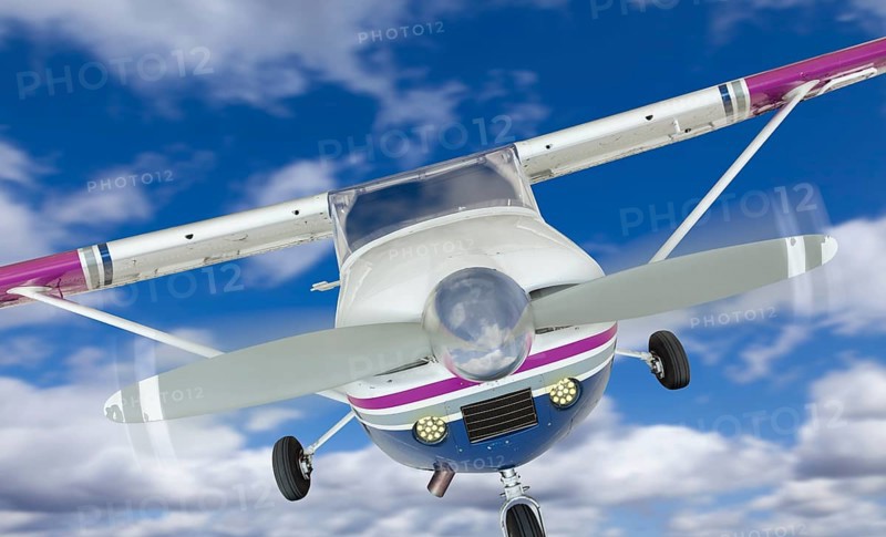 The front of A cessna 172 single propeller airplane in the sky