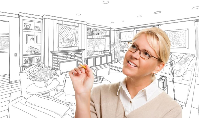 Woman with pencil over custom living room design drawing