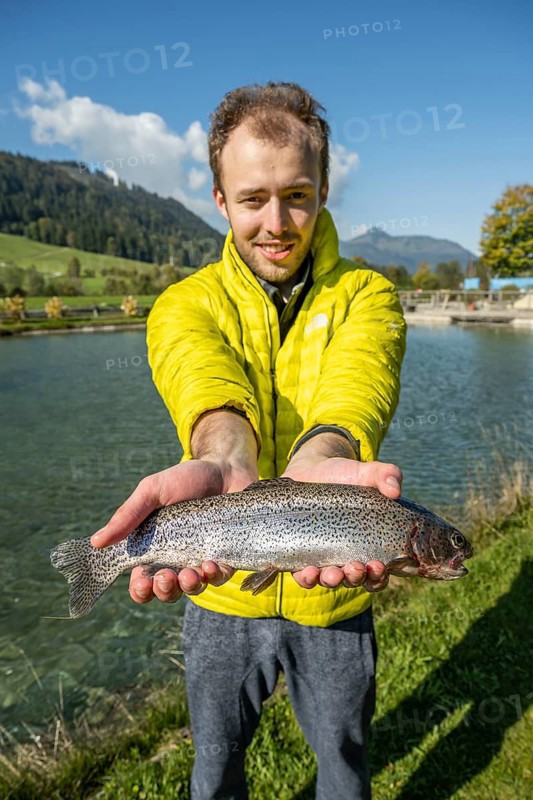 Man proudly holding caught trout