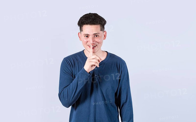 Man gesturing keep quiet