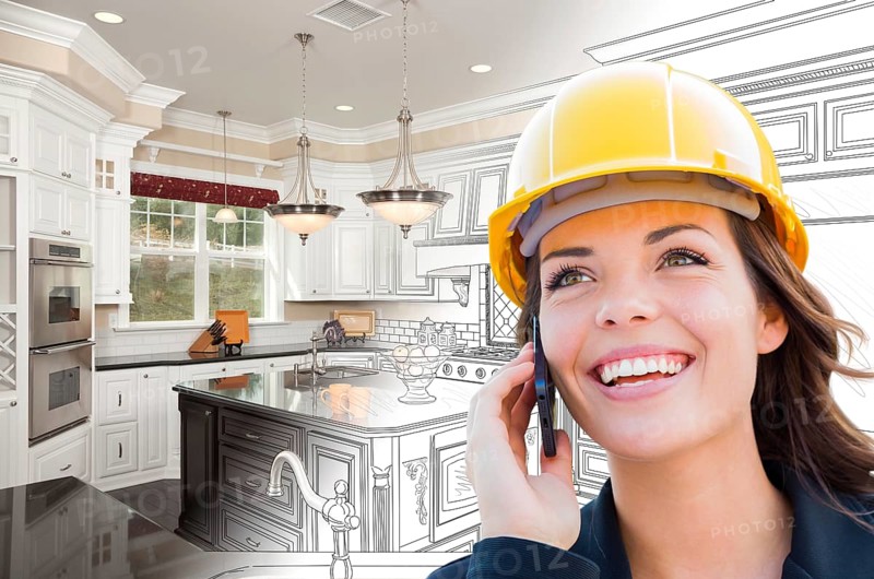 Female contractor using cell phone over kitchen drawing gradating to photo