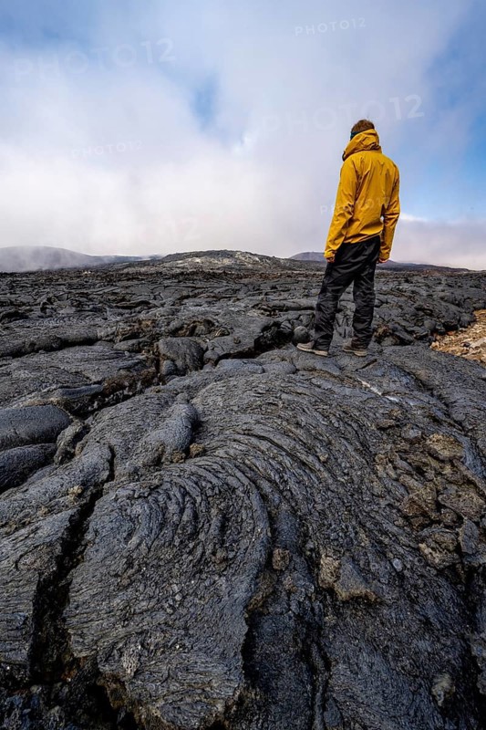 Tourist standing on petrified lava